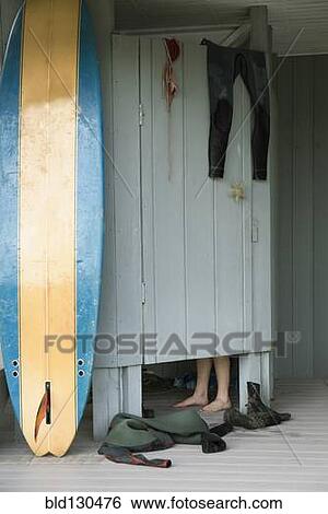 Caucasian surfer changing in beach hut View Large Photo Image Stock Photograph - Caucasian surfer changing in beach hut. Fotosearch