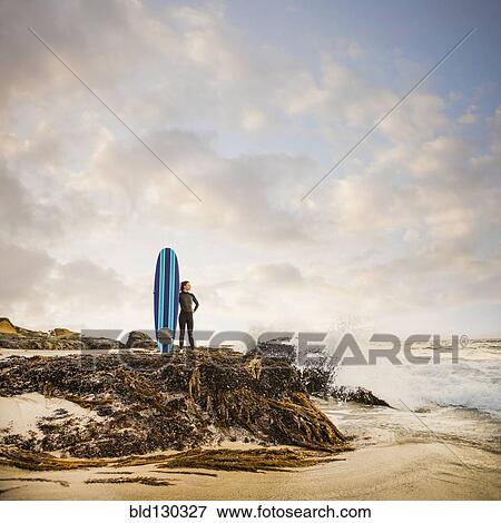 Caucasian surfer with board on beach View Large Photo Image Stock Photo - Caucasian surfer with board on beach. Fotosearch