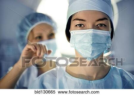 Caucasian surgeon wearing mask in operating room View Large Photo Image Stock Photography - Caucasian surgeon wearing mask in operating room. Fotosearch