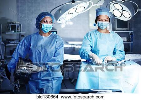Caucasian surgeons preparing operating room View Large Photo Image Picture - Caucasian surgeons preparing operating room. Fotosearch