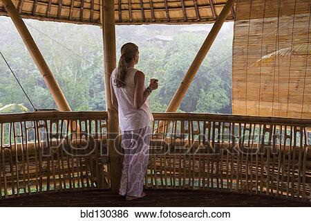 Caucasian woman overlooking view from balcony View Large Photo Image Stock Photograph - Caucasian woman overlooking view from balcony. Fotosearch