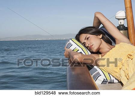 Caucasian woman relaxing on sailboat View Large Photo Image Stock Photo - Caucasian woman relaxing on sailboat. Fotosearch