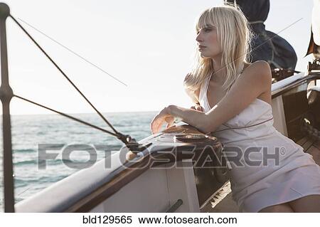 Caucasian woman relaxing on sailboat View Large Photo Image Stock Photography - Caucasian woman relaxing on sailboat. Fotosearch