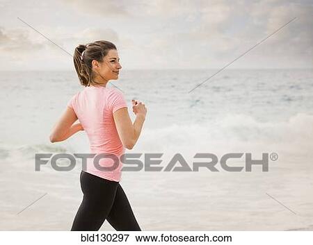 Caucasian woman running on beach View Large Photo Image Stock Photo - Caucasian woman running on beach. Fotosearch