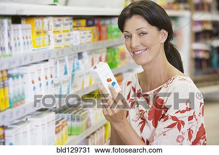 Caucasian woman shopping in drugstore View Large Photo Image Stock Image - Caucasian woman shopping in drugstore. Fotosearch