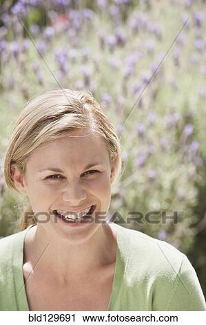 Caucasian woman smiling in lavender field View Large Photo Image Stock Image - Caucasian woman smiling in lavender field. Fotosearch