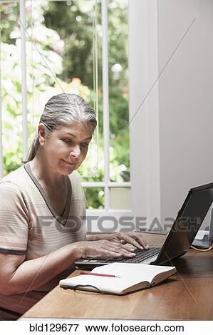 Caucasian woman transcribing journal View Large Photo Image Stock Photo - Caucasian woman transcribing journal. Fotosearch