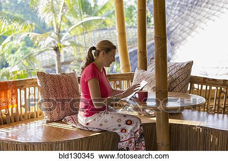 Caucasian woman using digital tablet on patio View Large Photo Image Stock Photography - Caucasian woman using digital tablet on patio. Fotosearch