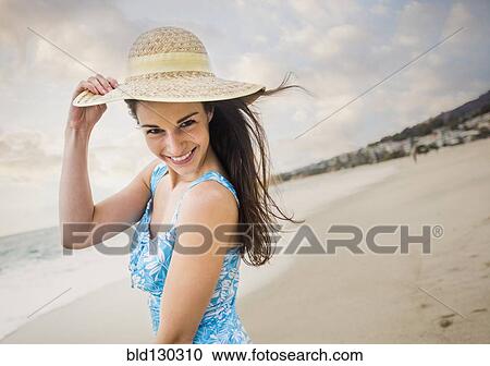 Caucasian woman wearing straw hat on beach View Large Photo Image Stock Image - Caucasian woman wearing straw hat on beach. Fotosearch