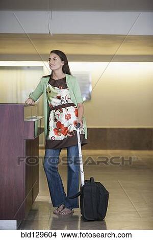 Caucasian woman with suitcase in hotel lobby View Large Photo Image Picture - Caucasian woman with suitcase in hotel lobby. Fotosearch