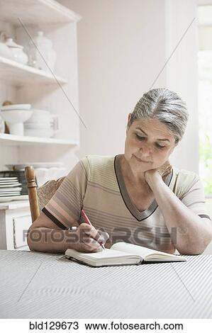 Caucasian woman writing in journal View Large Photo Image Stock Image - Caucasian woman writing in journal. Fotosearch