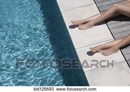 Caucasian women sunbathing by swimming pool View Large Photo Image Stock Image - Caucasian women sunbathing by swimming pool. Fotosearch
