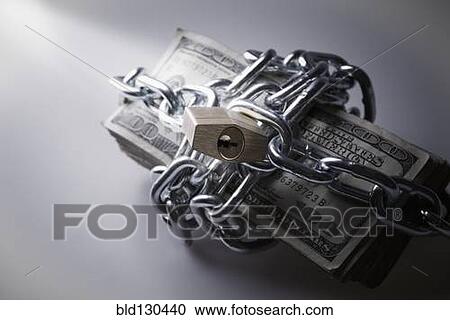 Stock Image - Chains and padlock around stack of dollar bills. Fotosearch