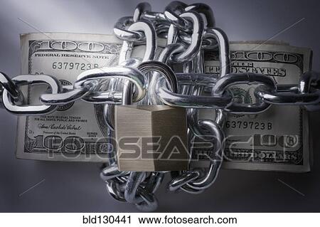 Stock Image - Chains and padlock around stack of dollar bills. Fotosearch