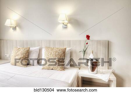 Champagne and glasses by bed in hotel room View Large Photo Image Picture - Champagne and glasses by bed in hotel room. Fotosearch