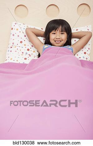 Stock Photo - Chinese girl laying in bed. Fotosearch