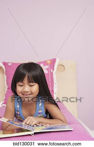Chinese girl reading on bed View Large Photo Image Stock Image - Chinese girl reading on bed. Fotosearch