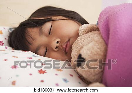 Chinese girl sleeping in bed View Large Photo Image Stock Photo - Chinese girl sleeping in bed. Fotosearch