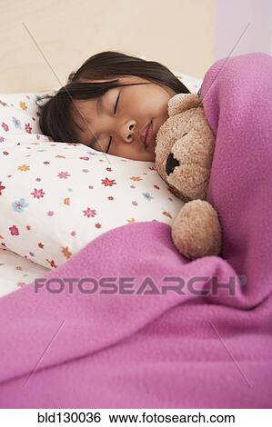Chinese girl sleeping in bed View Large Photo Image Stock Photograph - Chinese girl sleeping in bed. Fotosearch