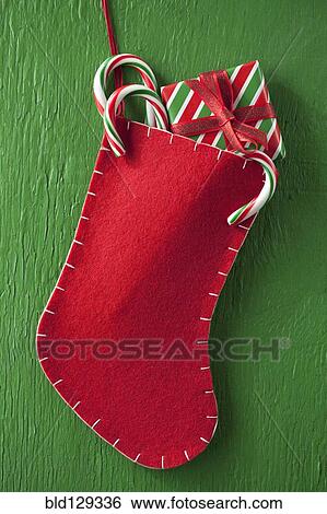 Christmas stocking with gift and candy canes View Large Photo Image Stock Photograph - Christmas stocking with gift and candy canes. Fotosearch