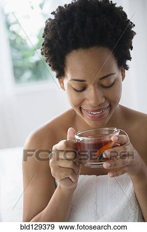 Close up of Black woman enjoying tea View Large Photo Image Stock Photo - Close up of Black woman enjoying tea. Fotosearch