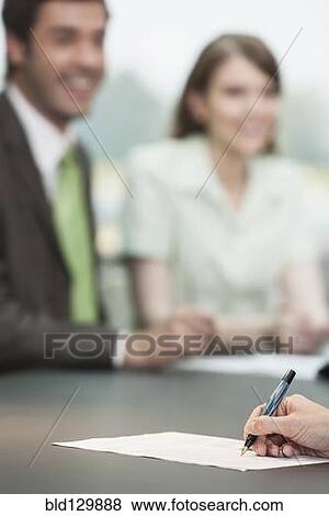 Close up of businesswoman making notes in meeting View Large Photo Image Stock Photo - Close up of businesswoman making notes in meeting. Fotosearch