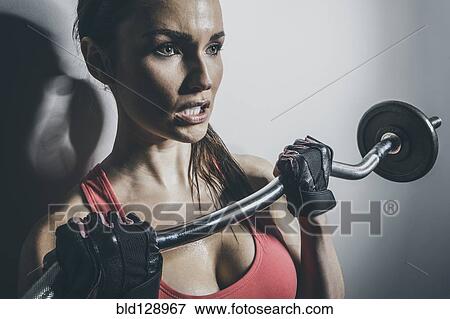 Close up of Caucasian woman lifting barbell View Large Photo Image Stock Photo - Close up of Caucasian woman lifting barbell. Fotosearch