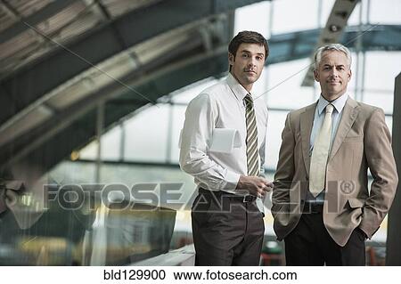 Confident businessmen in office View Large Photo Image Stock Image - Confident businessmen in office. Fotosearch