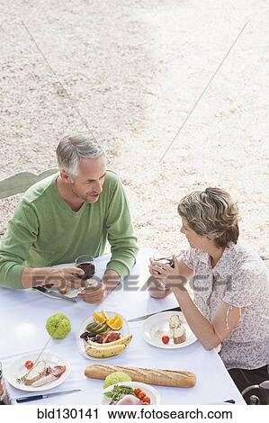 Couple eating together outdoors View Large Photo Image Stock Image - Couple eating together outdoors. Fotosearch