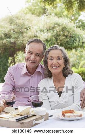 Stock Image - Couple eating together outdoors. Fotosearch