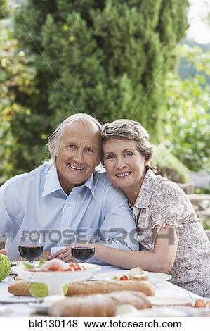 Couple eating together outdoors View Large Photo Image Stock Photo - Couple eating together outdoors. Fotosearch