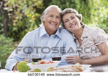 Stock Photo - Couple eating together outdoors. Fotosearch