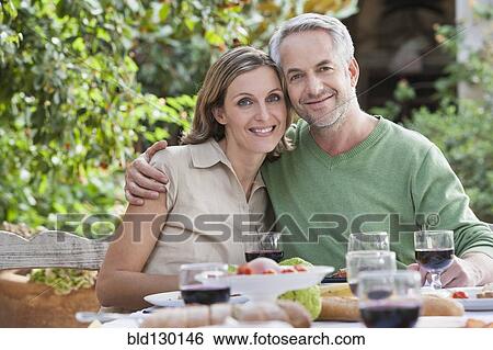 Couple eating together outdoors View Large Photo Image Stock Photograph - Couple eating together outdoors. Fotosearch