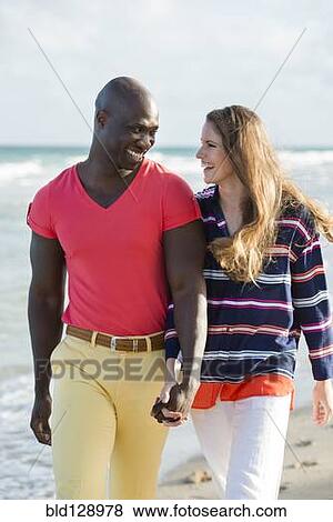 Couple holding hands on beach View Large Photo Image Stock Photo - Couple holding hands on beach. Fotosearch
