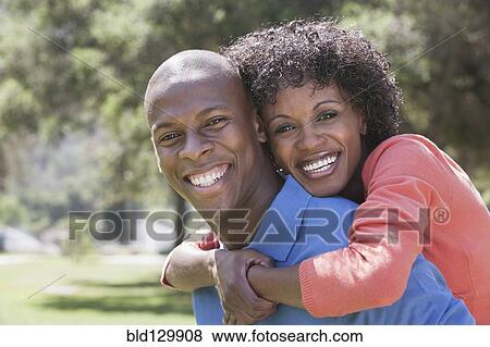 Stock Photo - Couple hugging in park. Fotosearch