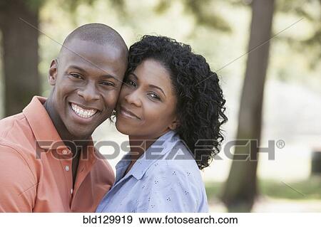 Couple hugging in park View Large Photo Image Stock Photo - Couple hugging in park. Fotosearch