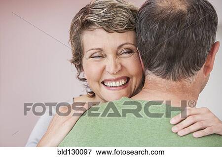 Couple hugging indoors View Large Photo Image Stock Photo - Couple hugging indoors. Fotosearch