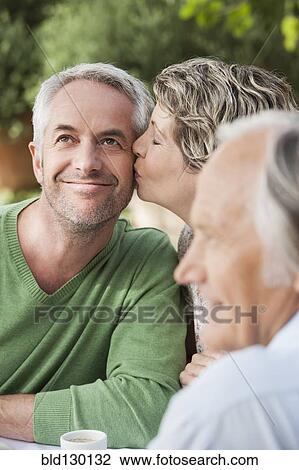 Stock Image - Couple kissing outdoors. Fotosearch