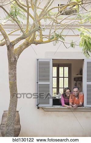 Stock Image - Couple looking out window. Fotosearch