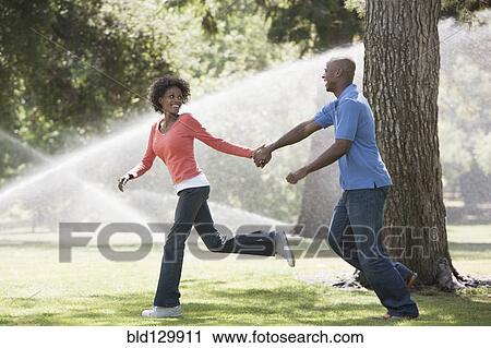 Couple running in park View Large Photo Image Stock Image - Couple running in park. Fotosearch
