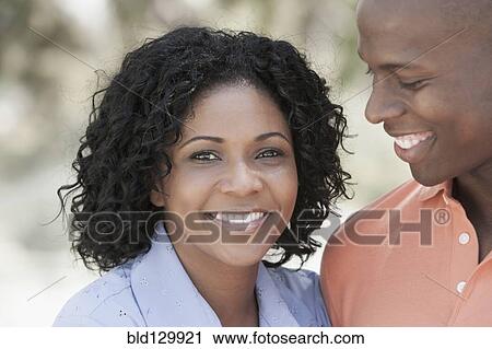 Stock Image - Couple smiling outdoors. Fotosearch