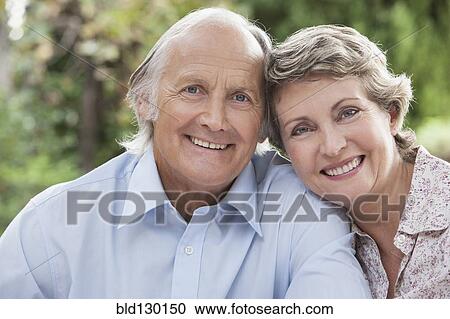 Couple smiling together outdoors View Large Photo Image Stock Image - Couple smiling together outdoors. Fotosearch