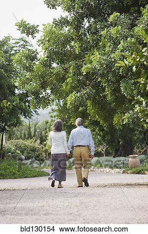 Couple walking together outdoors View Large Photo Image Picture - Couple walking together outdoors. Fotosearch