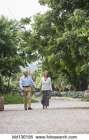 Stock Photography - Couple walking together outdoors. Fotosearch