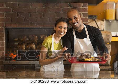 Couple working together in restaurant View Large Photo Image Stock Image - Couple working together in restaurant. Fotosearch