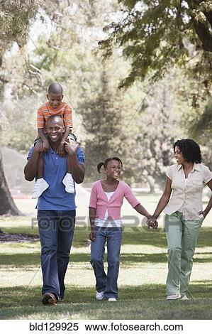 Family walking together in park View Large Photo Image Stock Photography - Family walking together in park. Fotosearch