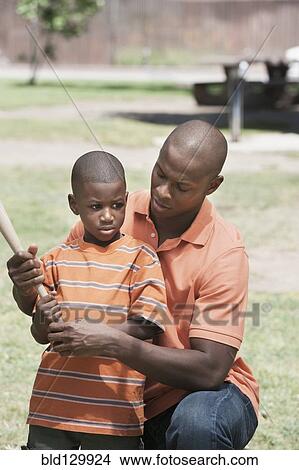Father teaching son to play baseball View Large Photo Image Picture - Father teaching son to play baseball. Fotosearch