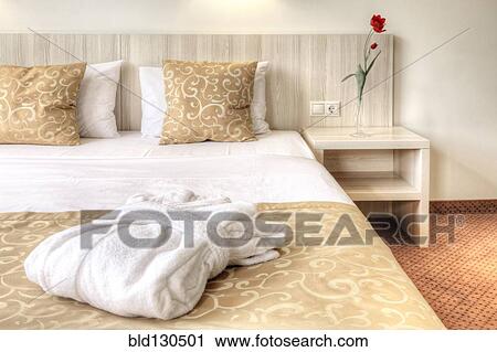 Folded robe on bed in hotel room View Large Photo Image Stock Image - Folded robe on bed in hotel room. Fotosearch