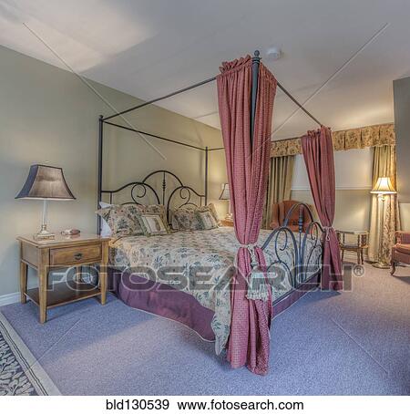 Stock Photo - Four poster bed in ornate bedroom. Fotosearch