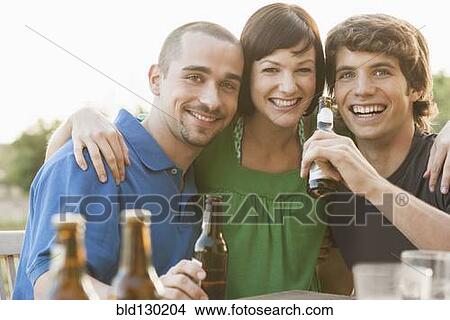 Friends drinking beer together outdoors View Large Photo Image Picture - Friends drinking beer together outdoors. Fotosearch
